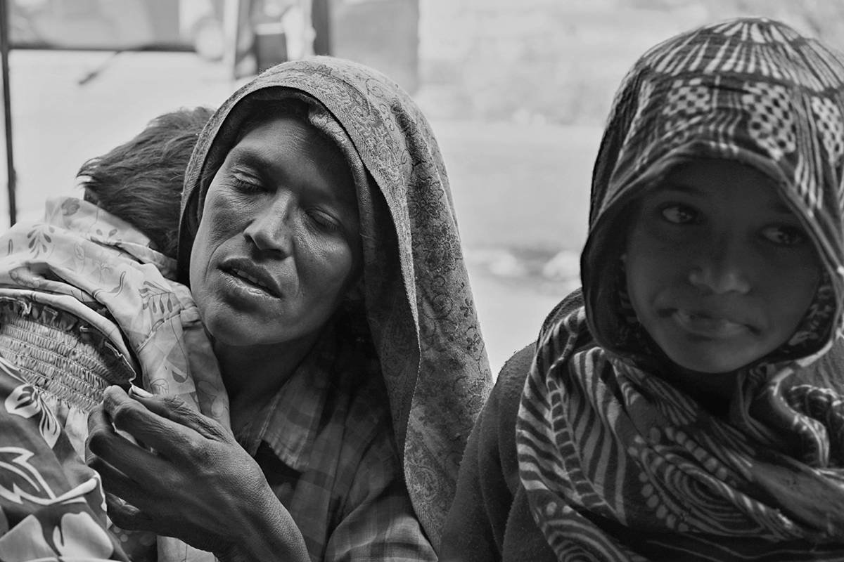 A woman holding a child close