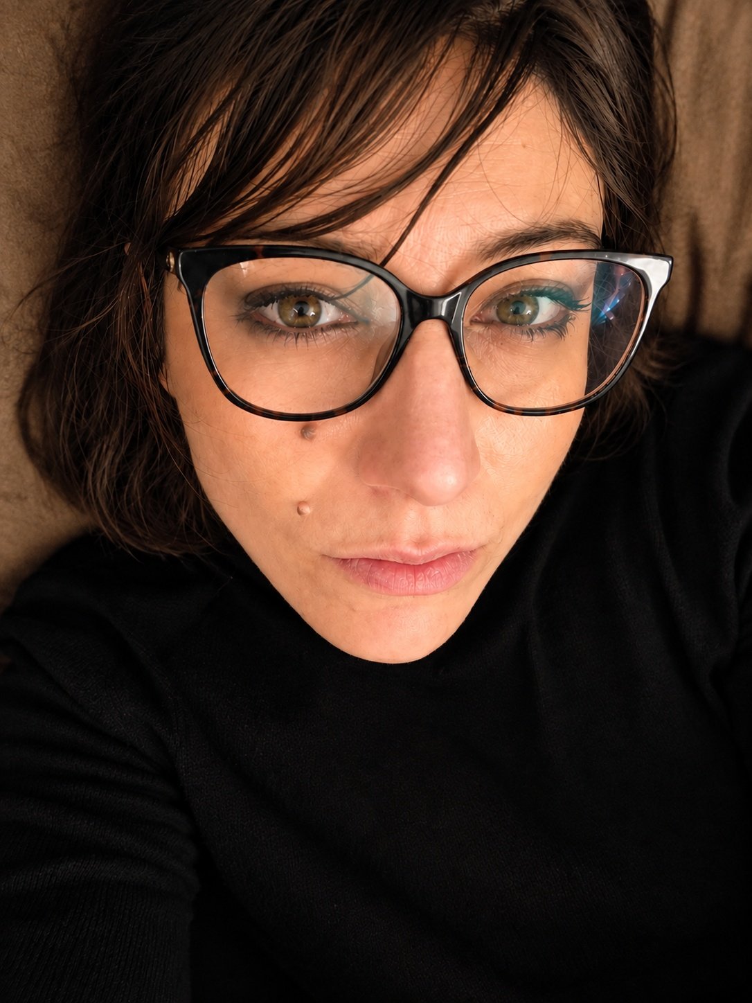 Portrait of documentary photographer Teresa Comito wearing glasses